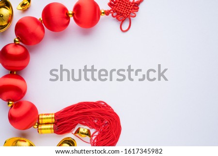 Chinese New Year decorations with white background with assorted festival decorations. Chinese characters means abundant of wealth, prosperity and luck. Flat lay or top view.