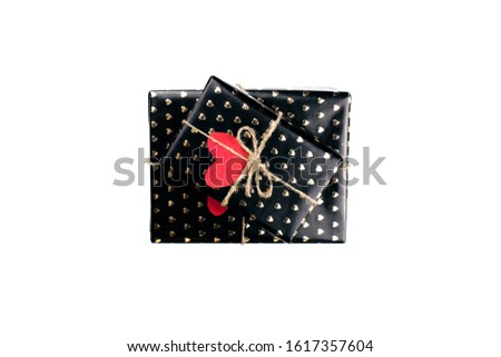 Gift boxes wrapped in black paper with hearts flat lay on white background with copy space. 8 march, Mother's day, Valentine's Day gifts top view. Celebrate concept. Template for web. Stock photo.