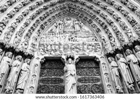 Paris, France - Notre Dame cathedral facade saint statues. UNESCO World Heritage Site. Black and white retro style.