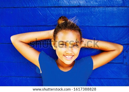 nice girl leaning on a blue pantone wall - cuba