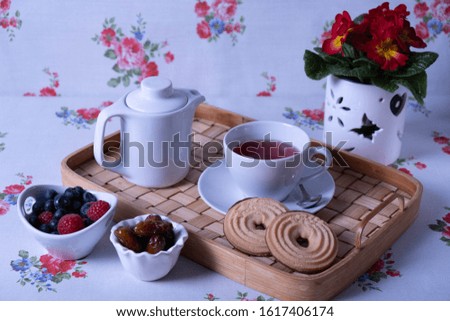 breakfast with muffins on the table and flowers