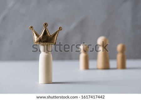 Happy Father's Day with wooden people father, mother, children on a gray concrete wall background. Father in the crown. family concept. 