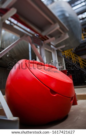Fire fighting equipment. Sand in red plastic tank close up photo. Oil refinery plant. Title: "FIRE SAND"