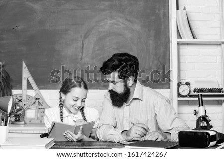 Capricious girl. daughter study with father. Teachers day. education child development. back to school. knowledge day. Home schooling. bearded man teacher with small girl in classroom.