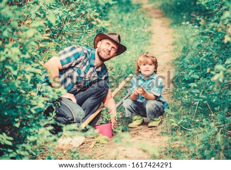 Eco farm. hoe, pot and shovel. Garden equipment. small boy child help father in farming. father and son in cowboy hat on ranch. happy earth day. Family tree nursering. Professional gardener.