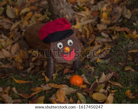 Tió in the forest with a tangerine, Tio is a Catalan Christmas tradition Royalty-Free Stock Photo #1617450247