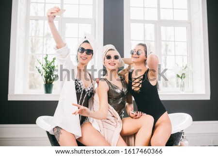 Picture showing group of happy friends in spa. girls with towels on heads having fun and taking selfie at home. Friendship, cosmetic, slumber party concept. Hen party with a bride in hotel.