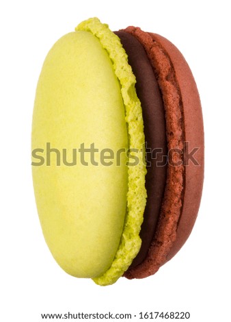 Macro photo of french caramel and pistachio macaroon or macaron isolated on white background, clipping path.