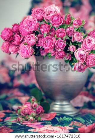 Close-up floral composition with a pink roses on a colorful background..Many beautiful fresh pink roses on a table.
