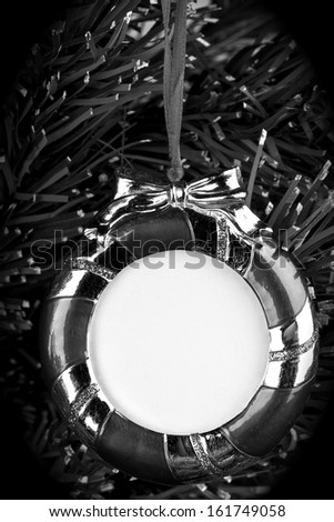 Christmas ornament.Black and white ,hanging photo frame on background.