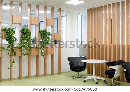 Office space interior with green plant corner for relaxing/ Greens in workspaces/ Winter garden in room/ Healthy lifestyle, tree lover and gardening concept Royalty-Free Stock Photo #1617495058