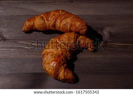 fresh french croissants on wooden backround