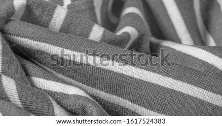 Texture, background, pattern, design, fabric from gray and white woolen stripes, woolen knitwear, which is elegant and pleasant to work with. Great for your projects.
