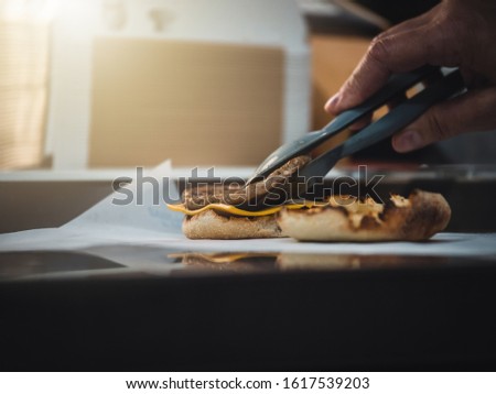 Preparation of burger. Professional chef is preparing burger. Burger making. Cooking hamburger concept.