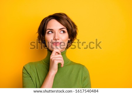 Closeup photo of amazing short hairdo lady looking up empty space deep thinking creative person arm on chin wear casual green turtleneck isolated yellow color background Royalty-Free Stock Photo #1617540484