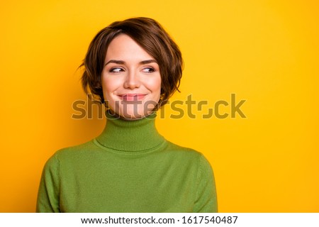 Closeup photo of funny short hairdo lady charming smiling good mood looking side empty space sly eyes wear casual green warm turtleneck isolated yellow color background