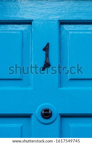 House number 1 on a blue wooden front door