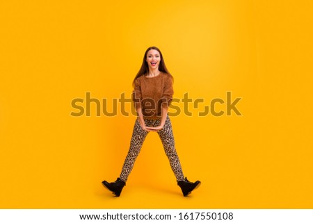 Full length photo of crazy funky lady jumping up high party cheerful mood weekend rejoicing funny position wear fluffy sweater leopard pants shoes isolated yellow color background