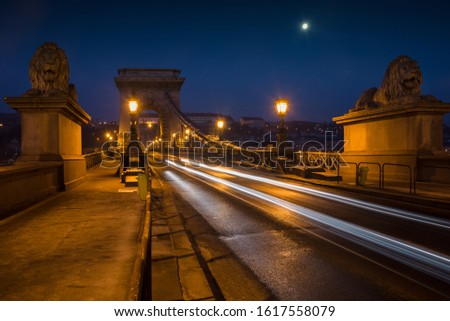 Beautiful Long exposure image of Chain Bridge in Budapest, Hungary. View of light trails along the road. Night photography.