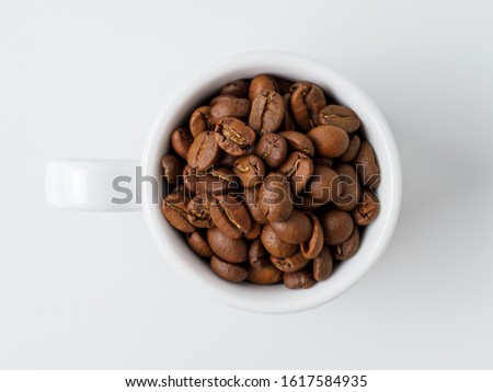 Roasted coffee beans in the cup.