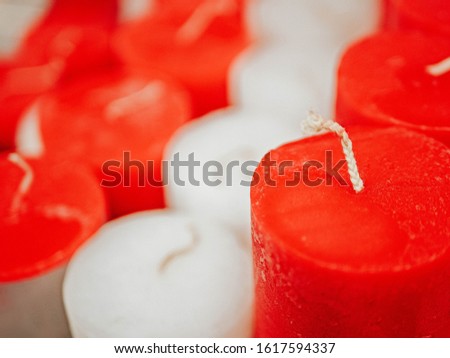 Macro photo close up candle. Stock photo decor red and white aroma candles. Wallpaper fragrance candles, decoration, hygge and cosiness concept