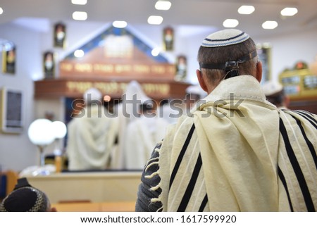 back of a jewish man on synagogue praying Royalty-Free Stock Photo #1617599920