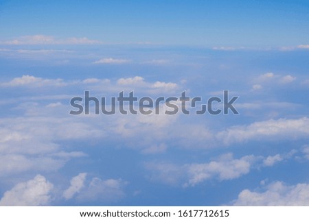 Fluffy white cloud with blue sky above view from airplane sky background