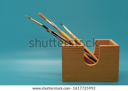 Clean paintbrushes in a holder. Royalty-Free Stock Photo #1617725992