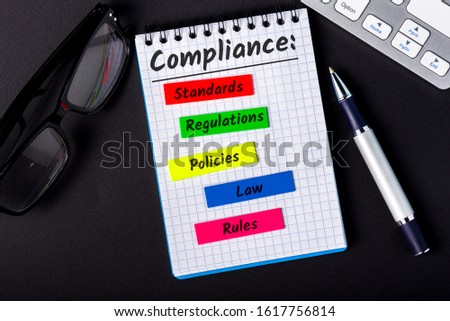 Compliance concept, components of compliance policies at notepad at office workplace Royalty-Free Stock Photo #1617756814