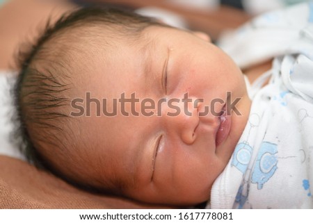 Newborn baby asleep at hospitol,Portrait of Asian cute boy newborn lying on the bed
