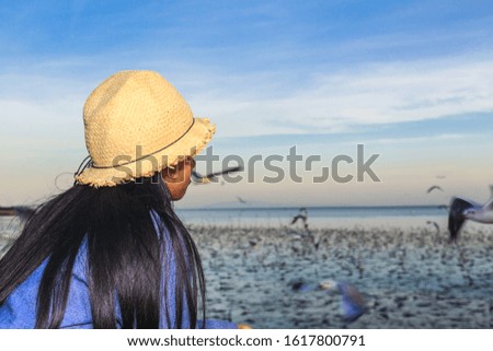 Girls watch looking at the seagulls in the sea