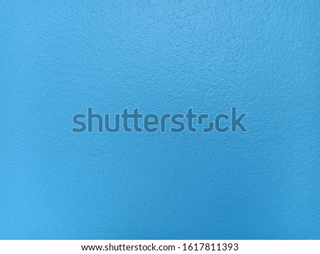 The background is made of blue colored concrete.