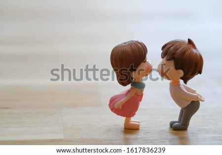 The Miniature Couple dolls Boy and Girl Romantic Kiss with Heart around the Ground  for Background for valentine's Day Concept