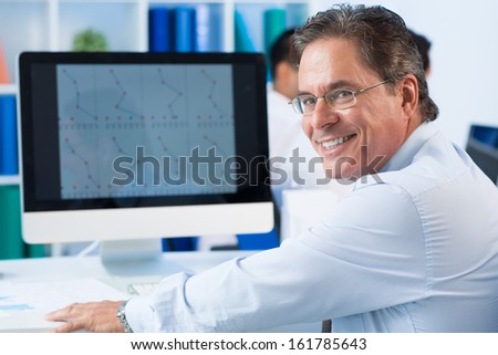 Portrait of smart businessman looking at camera with smile