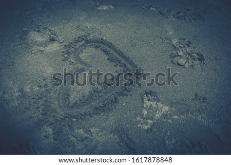 Heart drawn in the sand, concept of love. 
