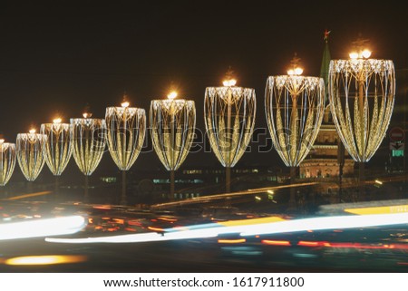 Long exposure photography of street lanterns decorated with flashlights in Moscow. Right geometrical forms. Concepts of festive city decoration. Beauty of the capotal in the winter night.