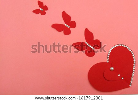 Three butterfly or a heart cutting red pappers isolated on pink background, valentine day image walpappers,greeting card or other card ideas