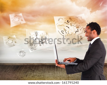 Composite image of smiling businessman working on laptop 