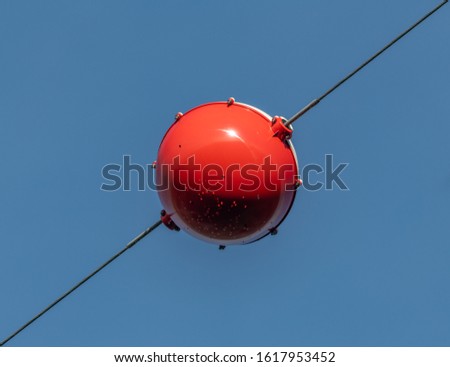 red/white signal sphere on high voltage lines, tech Royalty-Free Stock Photo #1617953452