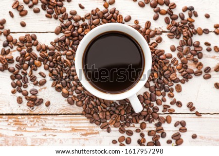 Cup of hot coffee on wooden table