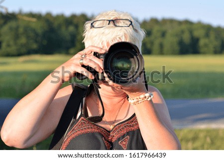 Woman taking pictures in summer