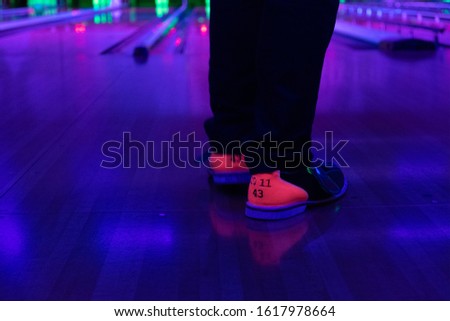 Man Wearing Bowling Shoes in a bowling Lanes