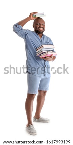 African-American man with books on white background