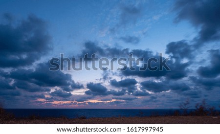 View of setting sun over Black Sea - clouds above horizont