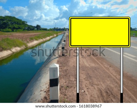 Yellow blank traffic sign no message The background of the road is blurred