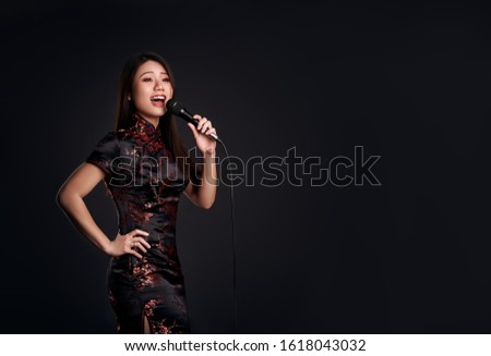 Korean girl with a microphone in hand sings 