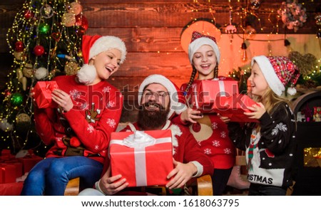 Boxing day. Happy holidays. Spend time with your family. Christmas tradition. Father bearded man and mother with cute daughters christmas tree background. Parents and children opening christmas gifts.