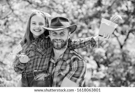 father and daughter. family farm. agriculture. little girl and happy man dad. earth day. new life. spring village country. ecology environment. soils and fertilizers. I love to work with plants.