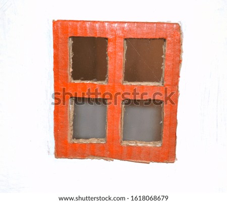 Closeup of brick red frame of window made of cartoon against white background 