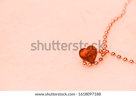 one red heart in the snow on Valentine's Day. close-up, background image. Lush lava background 2020 color